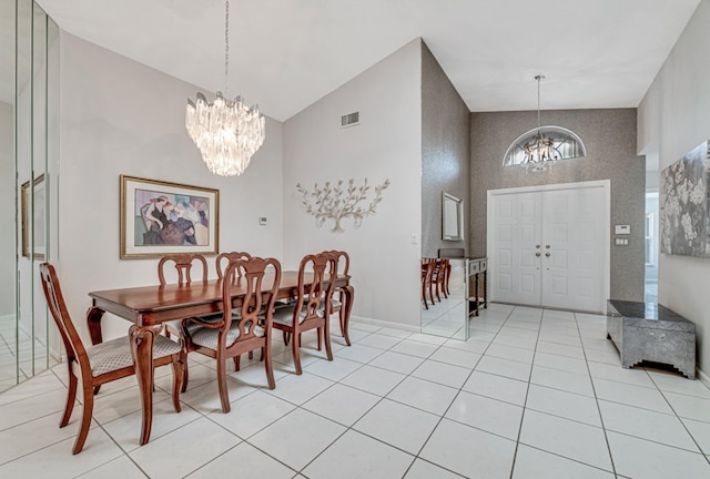 tiled dining space with a notable chandelier and high vaulted ceiling