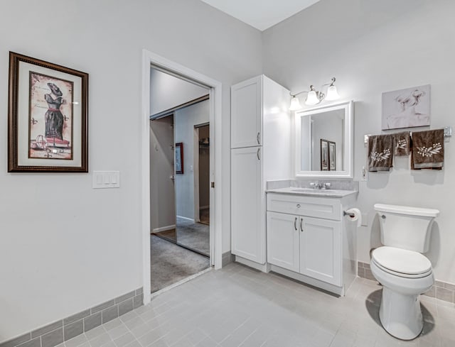 bathroom featuring tile patterned flooring, vanity, and toilet