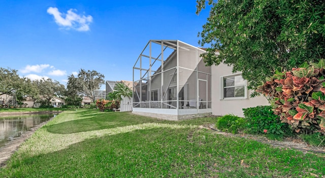 exterior space with a lanai and a water view