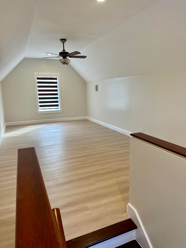 bonus room featuring light wood-type flooring, vaulted ceiling, and ceiling fan