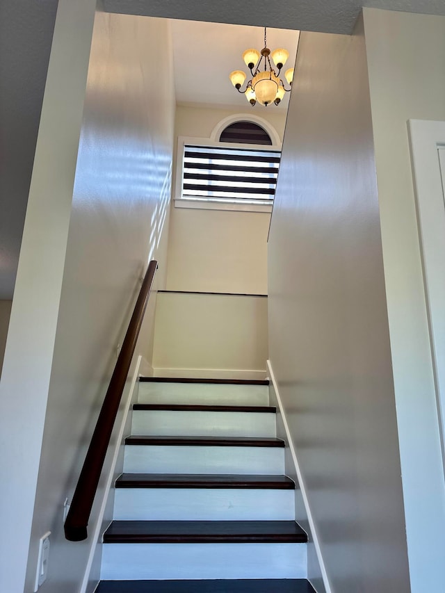 stairway with a chandelier