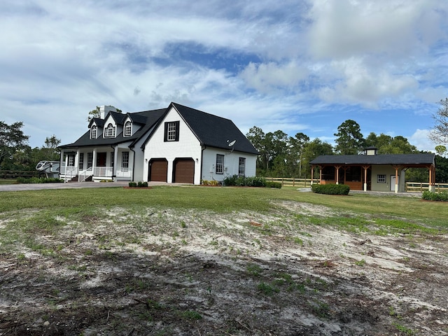 view of front facade with a garage, a carport, covered porch, and a front lawn