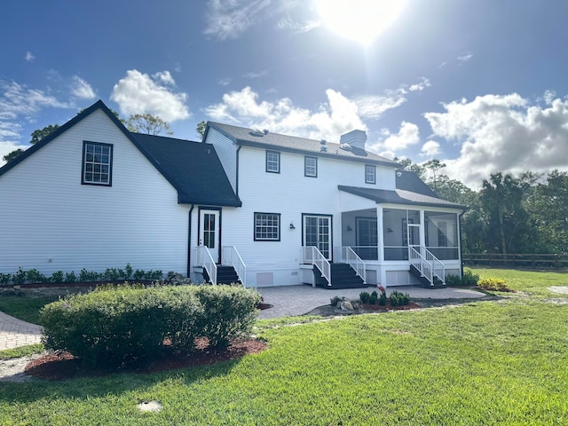 back of house featuring a patio, a sunroom, and a yard