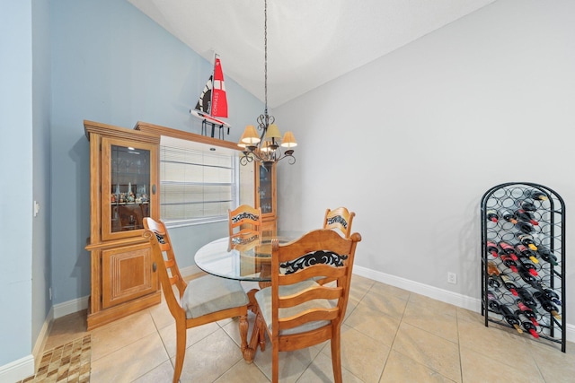 dining space with a notable chandelier, light tile patterned floors, and high vaulted ceiling