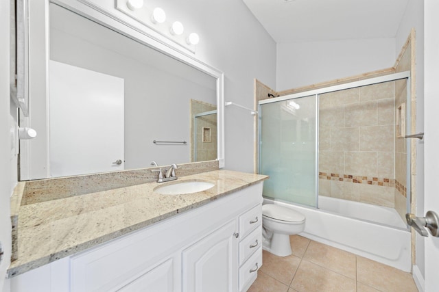 full bathroom with tile patterned flooring, vanity, combined bath / shower with glass door, and toilet