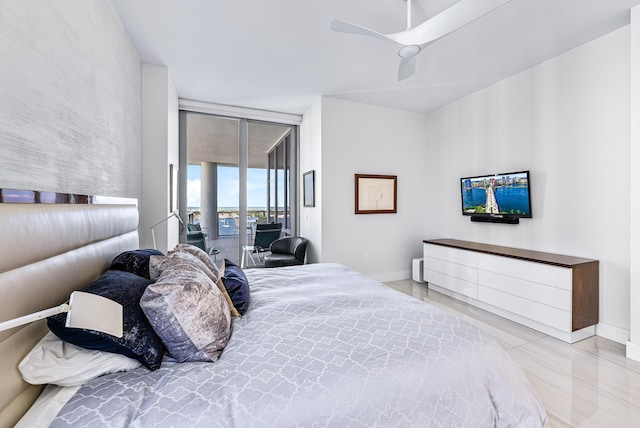 bedroom featuring access to outside, expansive windows, baseboards, and ceiling fan