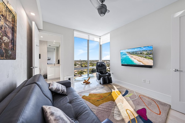 living room with a wall of windows and light hardwood / wood-style flooring