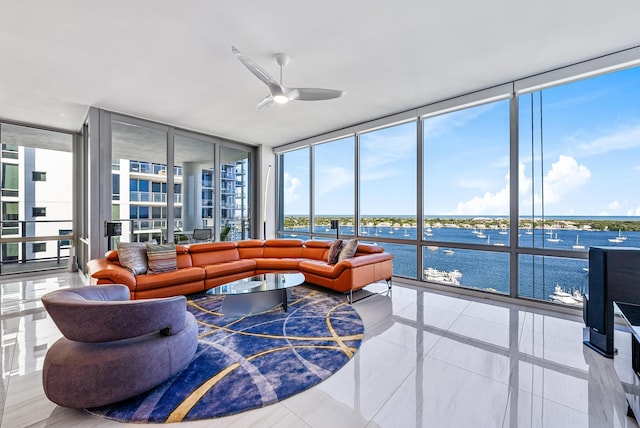 sunroom featuring a water view and ceiling fan