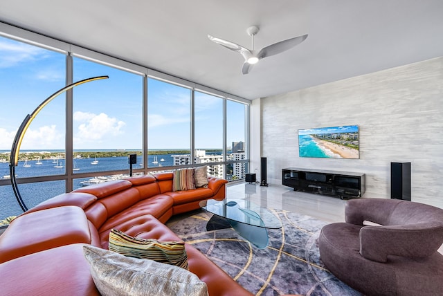 living room featuring ceiling fan and expansive windows