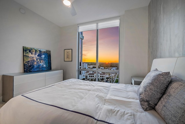 bedroom with expansive windows and a ceiling fan