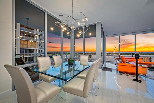 dining room with an inviting chandelier and a wall of windows