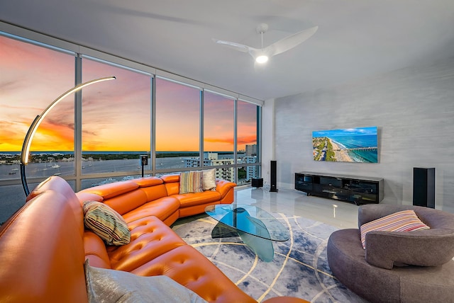 living room with ceiling fan and a wall of windows