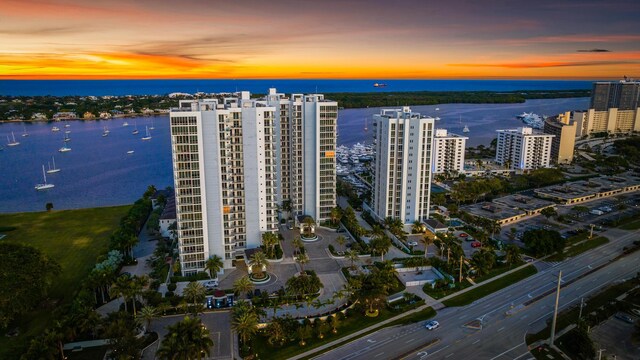 aerial view at dusk featuring a water view