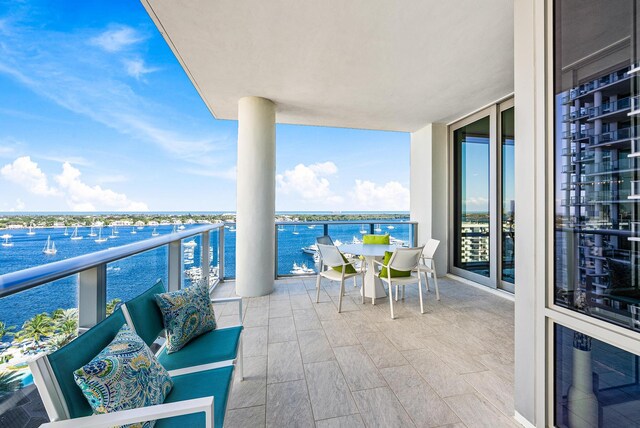 sunroom featuring a chandelier and a water view