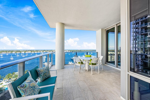 balcony with a water view and an outdoor hangout area