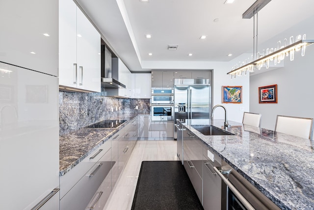 kitchen featuring stainless steel appliances, gray cabinets, tasteful backsplash, modern cabinets, and pendant lighting