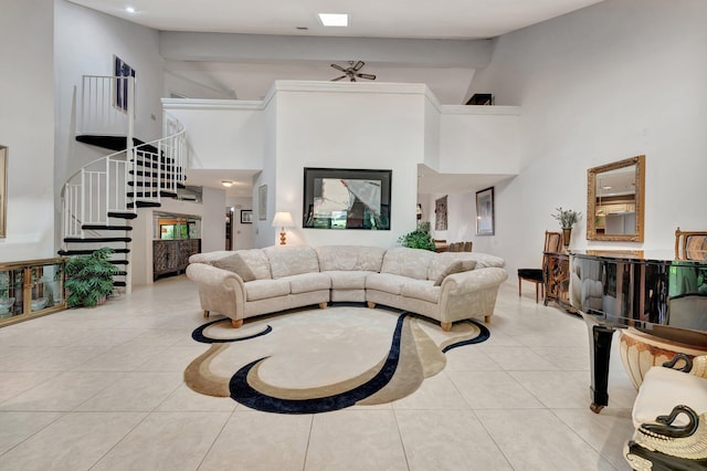 living room featuring a towering ceiling, beamed ceiling, and light tile patterned flooring