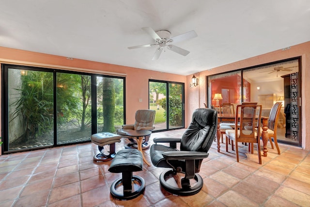 interior space with ornamental molding, a wealth of natural light, and ceiling fan