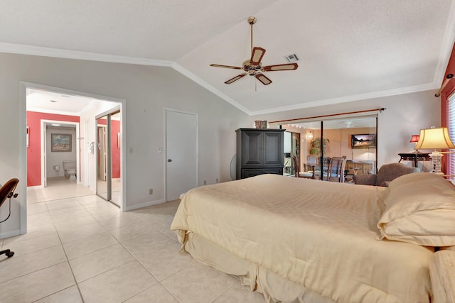 tiled bedroom with a textured ceiling, vaulted ceiling, ceiling fan, and crown molding