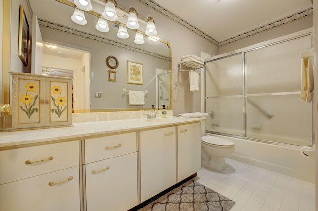 full bathroom featuring toilet, vanity, tile patterned floors, and enclosed tub / shower combo