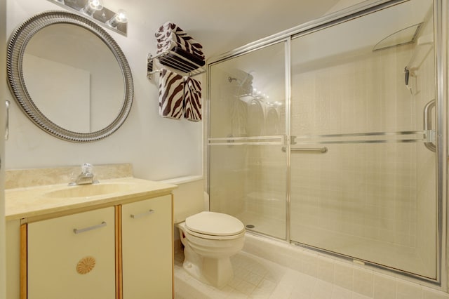 bathroom featuring walk in shower, vanity, toilet, and tile patterned flooring