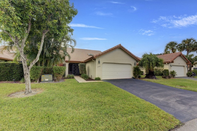 mediterranean / spanish-style house with a front lawn and a garage