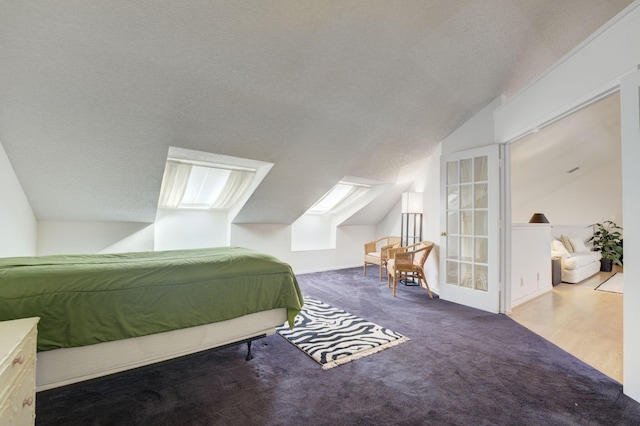 bedroom featuring carpet floors, lofted ceiling, and a textured ceiling