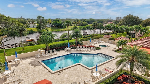 view of swimming pool with a patio and a yard