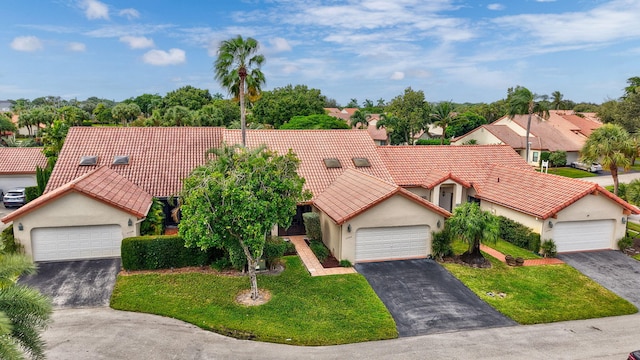 view of front of property with a front yard and a garage