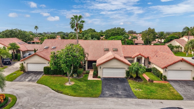 view of front of house with a garage and a front lawn