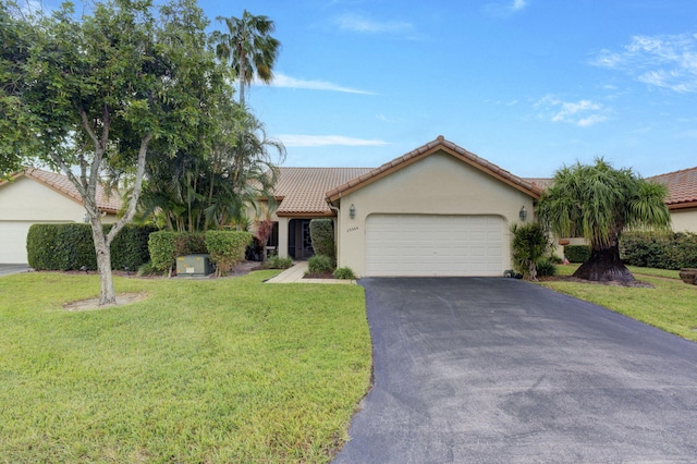 view of front of property with a garage and a front yard