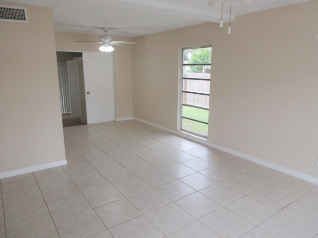 empty room featuring light tile patterned floors and ceiling fan