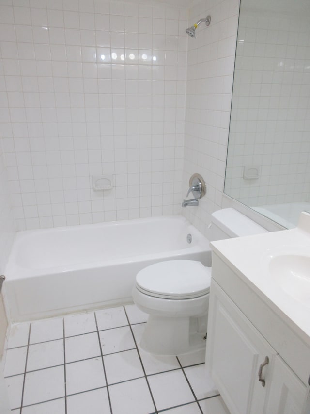 full bathroom featuring vanity, tile patterned floors, toilet, and tiled shower / bath combo