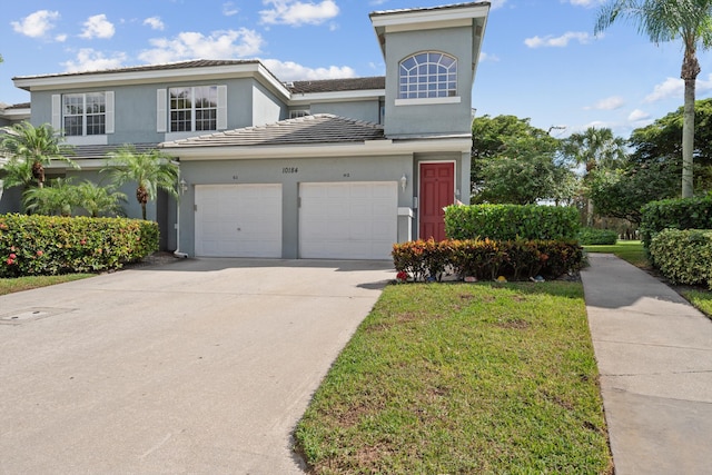 view of front property with a front lawn and a garage