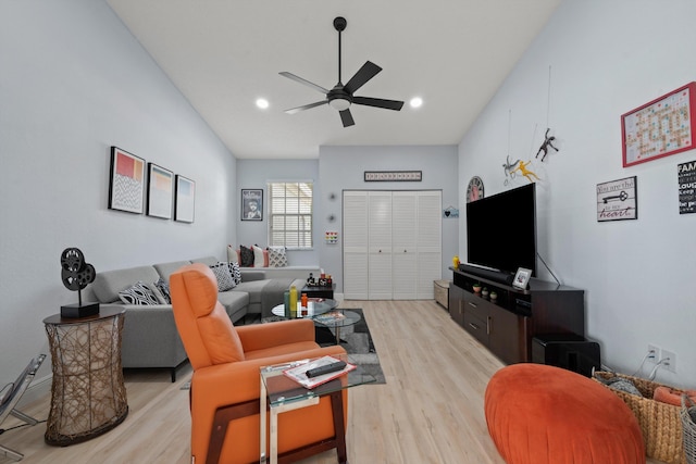 living room featuring ceiling fan and light wood-type flooring