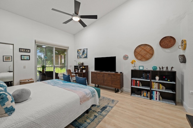 bedroom featuring access to exterior, ceiling fan, high vaulted ceiling, and wood-type flooring