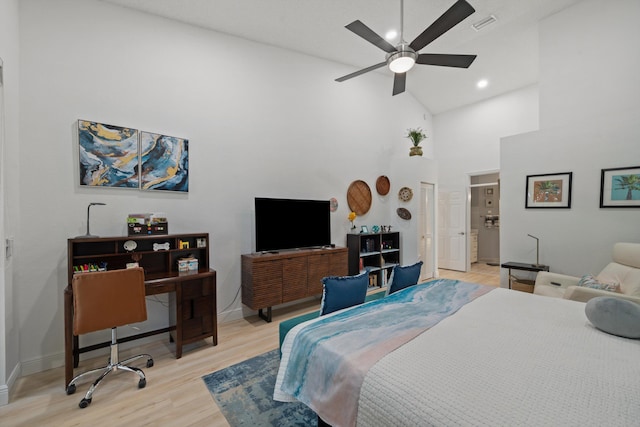 bedroom with ceiling fan, high vaulted ceiling, and light wood-type flooring