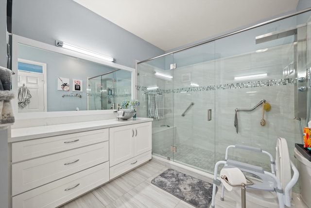 bathroom with tile patterned floors, vanity, and a shower with shower door