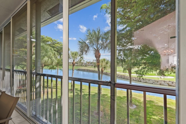 unfurnished sunroom featuring plenty of natural light and a water view