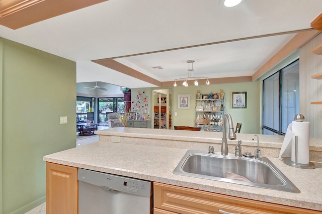 kitchen with light brown cabinetry, stainless steel dishwasher, sink, and ceiling fan