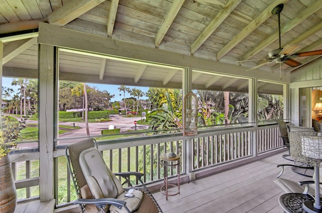 sunroom featuring wooden ceiling, ceiling fan, plenty of natural light, and vaulted ceiling with beams