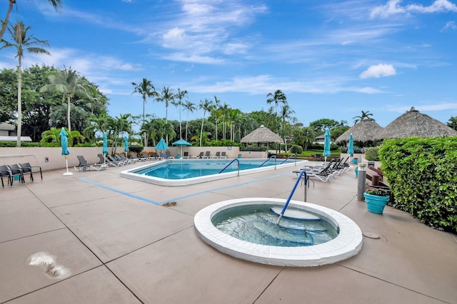 view of pool with a community hot tub and a patio area