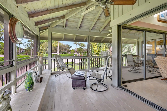 sunroom / solarium featuring vaulted ceiling with beams, a healthy amount of sunlight, ceiling fan, and wood ceiling