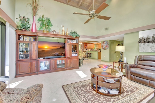 tiled living room featuring ceiling fan, beam ceiling, and high vaulted ceiling