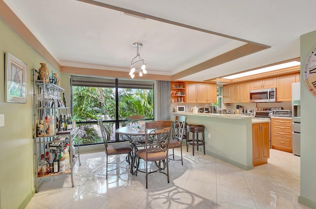 tiled dining space with an inviting chandelier