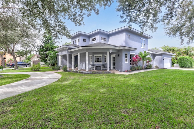 view of front of house featuring a porch, a front lawn, and a garage