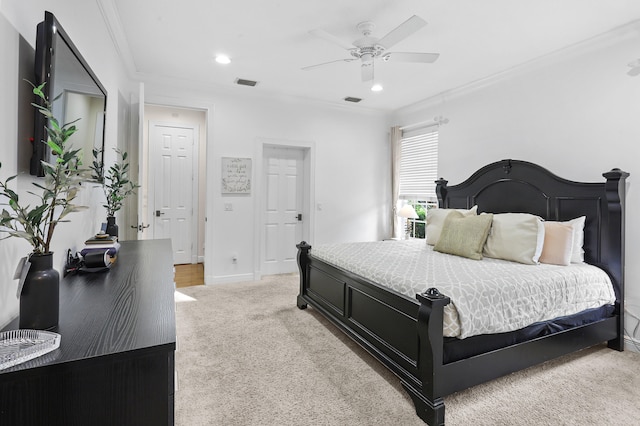 bedroom with ornamental molding, light colored carpet, and ceiling fan