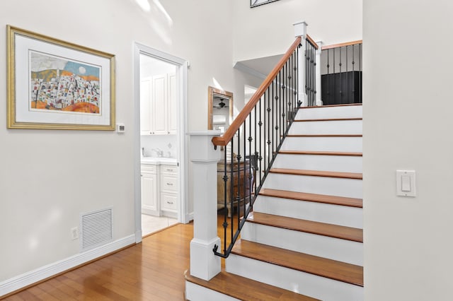 staircase with wood-type flooring