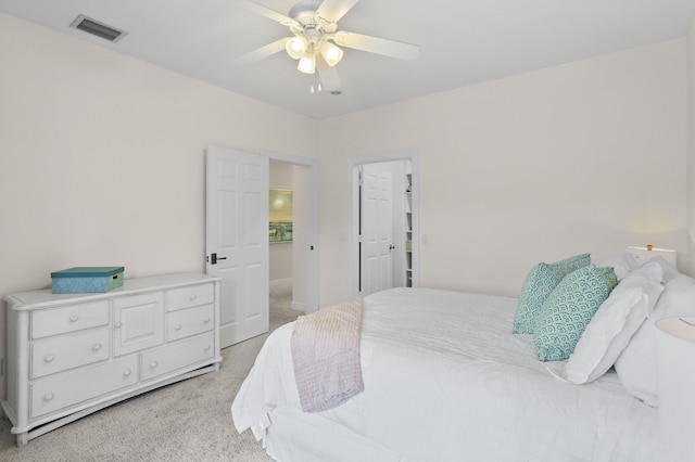 bedroom featuring light carpet and ceiling fan