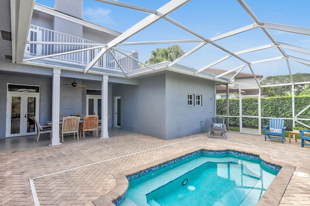 view of swimming pool with a lanai, french doors, ceiling fan, and a patio